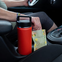Candied Ginger - bag next to a tumbler in car cupholders