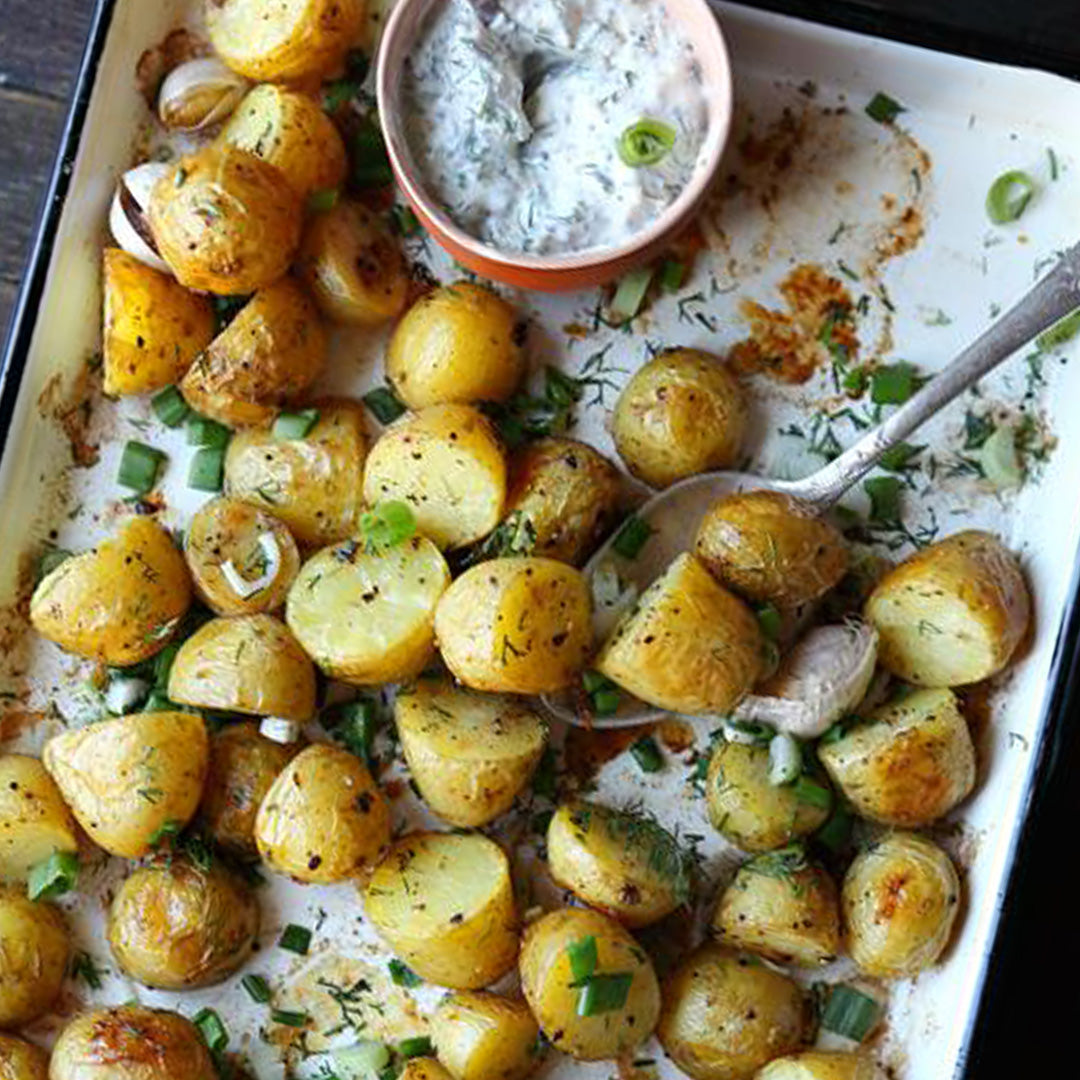 Seasoned, baked, and halved mini potatoes with a dill dip