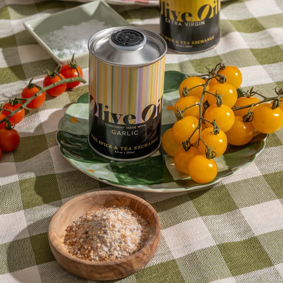 Garlic Olive Oil on plate next to sea salt and yellow tomatoes