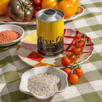 Lemon Extra Virgin Olive Oil on place next to Rosemary sea salt and tomatoes